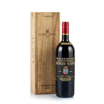 the bottle of red wine is next to a wooden box