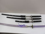 four different types of swords on display on a table