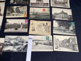 several old black and white photographs of buildings and people on a table
