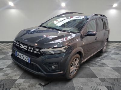 the grey car is parked on a checkered floor in the garage