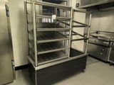 a commercial kitchen with stainless steel appliances and a refrigerator