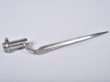 a small metal object that is on a white surface