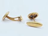 two pairs of gold plated cufflinks on a white background