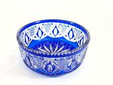 blue glass bowl with a design on the rim