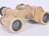an old pair of binoculars sitting on top of a white surface