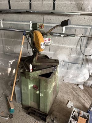 a machine that is sitting in a garage next to a trash can