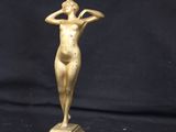 bronze statue of a woman holding her head on a marble base