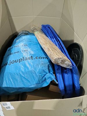 a blue bag in a cardboard box with a blue handle