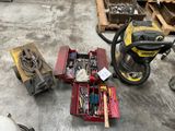 many tools that are sitting on the floor next to a vacuum