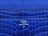 a blue hermes card case with the name hermes paris made in france on it