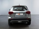 the rear end of a silver car in a white room