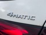 the rear end of a white car with the 4matic logo on it