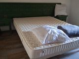 a bed that has a mattress on it in a room