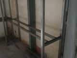 a metal shelf in the corner of a room