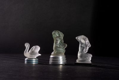 three pieces of glass sitting on top of a table next to each other