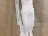 the mannequin is wearing a white dress on a mannequin stand