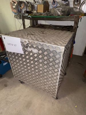 a metal box with a sign on it in a garage