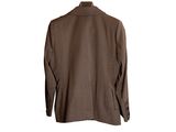 a brown jacket hanging on a hanger on a white wall