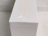 a white box sitting on the floor next to a toilet