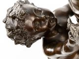 bronze statue of a boy holding a bird in his hand