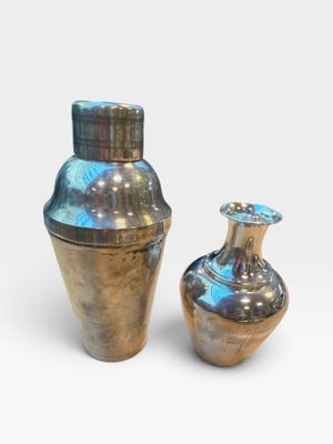 two vases sitting next to each other on a white surface