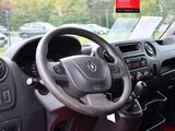a steering wheel and dashboard of a car in a parking lot
