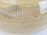 a large brown vase with a spiral design on it