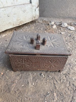 a small wooden box that is sitting on the ground