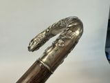 a close up of a cane with a metal handle