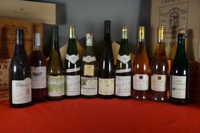 several bottles of wine are lined up on a red table
