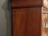 a wooden cabinet in the corner of a room