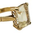 an image of a gold ring with a green stone in it