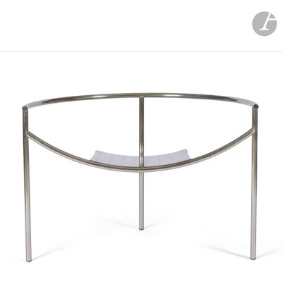 a close up of a curved glass table with a metal frame