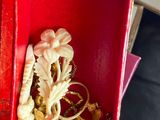 someone is holding a red box with a ring inside of it