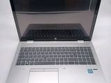 a laptop that is open on a white table