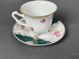 a cup and saucer on a saucer on a table