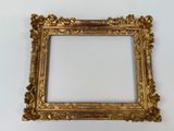 an old gold frame with a white background and a white wall