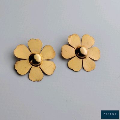 une paire de boucles d'oreilles à clous en forme de fleur, de couleur dorée, sur fond blanc