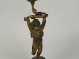 bronze figurine of a woman holding a flower pot on a marble base