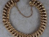 a gold chain bracelet with a clasp on it