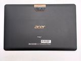 the back of a black laptop with a gold edge on a white surface