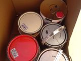 a box full of paint that is sitting on the floor