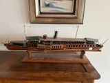 a wooden model of a ship on a table