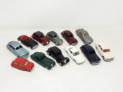 several toy cars are lined up in a row on a white surface