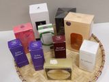many different types of perfumes in a basket on a table