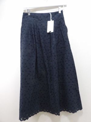 the skirt is made of a dark blue polka dot print fabric