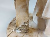 a white marble pedestal with a bird on top of it