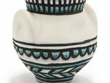 un vase blanc orné d'un motif bleu et noir