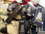 a pile of electronics that is sitting on a bed