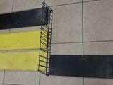 two shelves that have yellow and black strips on them